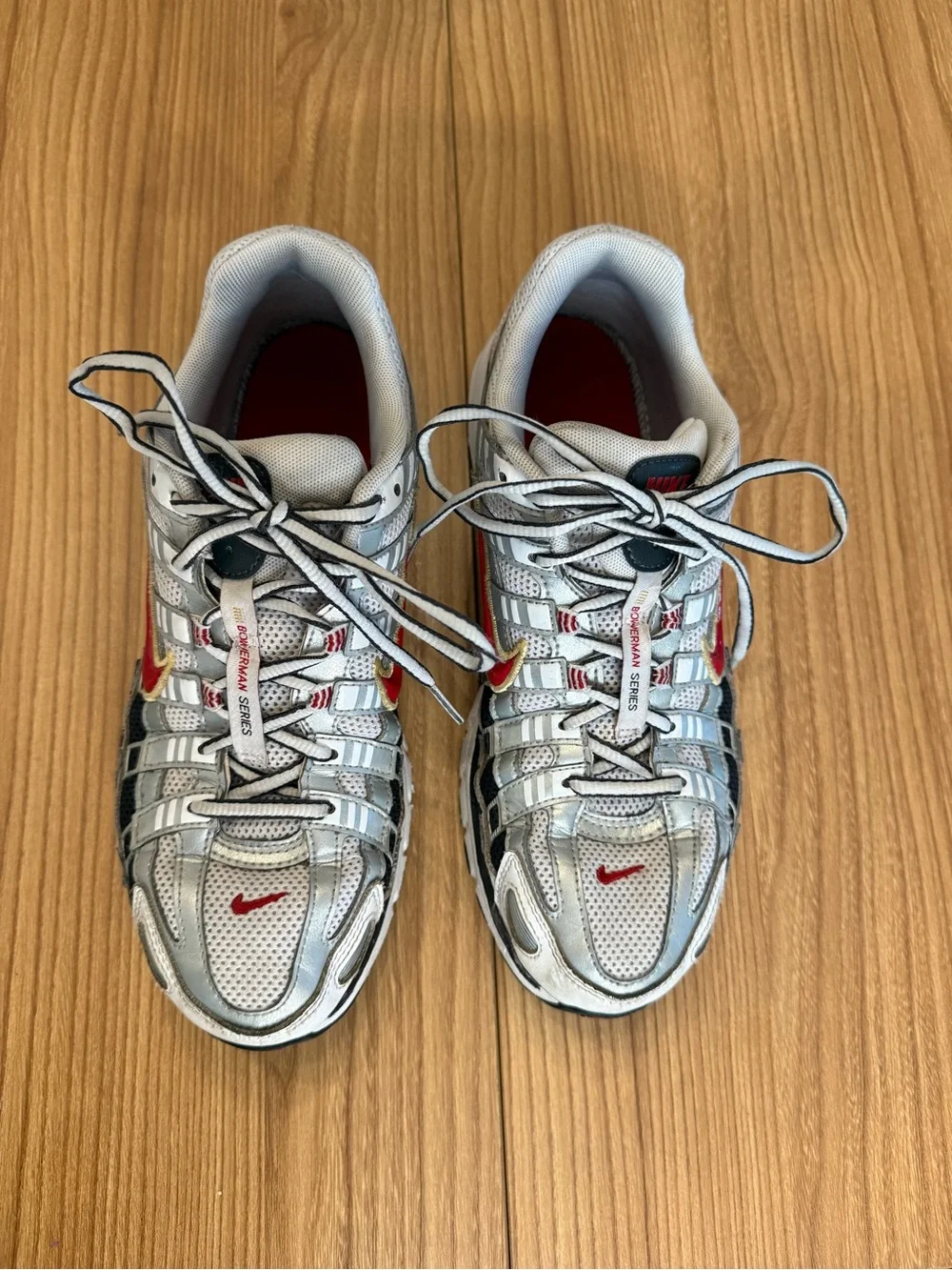 Nike Silver Athletic Shoes with Red and Gold Swoosh